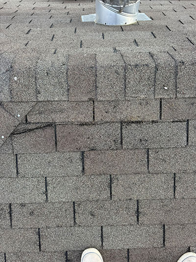 Close inspection of architectural shingles around a roof vent in Haslet, TX