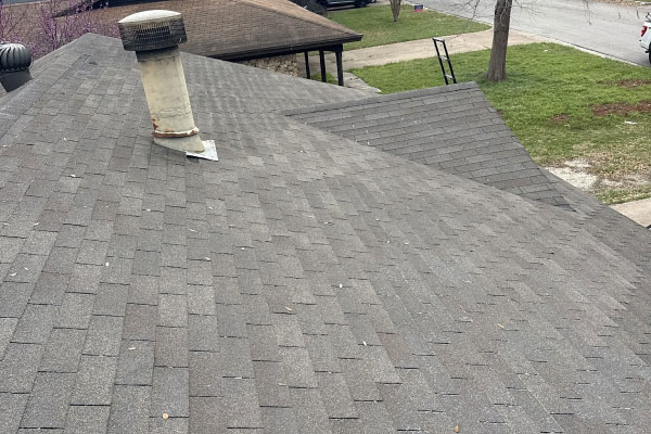 Freshly shingled roof slope with a metal turbine vent and ridge line in Haslet, TX