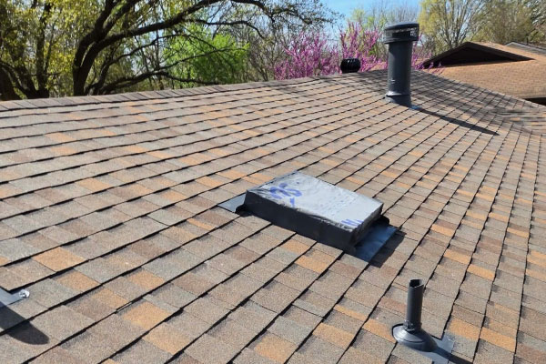 Multi-gable shingle roof with dormers viewed across the ridge in Haslet, TX