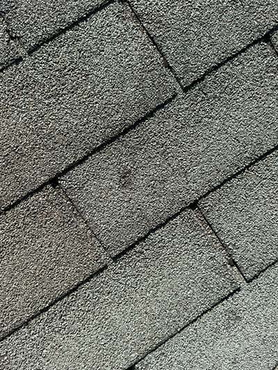 Detail of asphalt shingle surface texture and granules in Haslet, TX